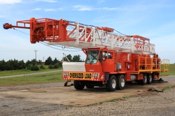 Service King Manufacturing SK 375 Carrier mount rig with 96 foot workover derrick.